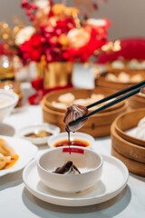 Close up on a chocolate xiao long bao (dumpling) with molten chocolate sauce