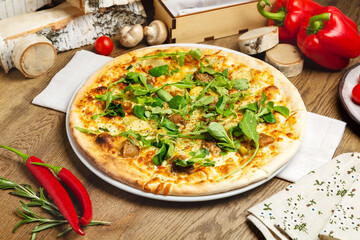 Italian thin pizza with meat, cheese and arugula. Cafe, lunch.