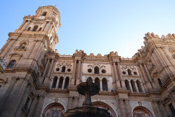 Naklejka premium Fountain with the Cathedral of Malaga- Basilica of the Incarnation in the background, Andalusia, Spain 