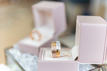 Wedding ring set in a pink ring box on a white background.