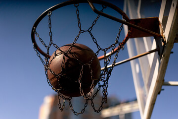close up a sports ground basketball field shot from below basketball hoop with chains hitting the...
