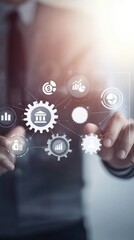 Fototapeta premium Businessman touching digital gears and icons on virtual screen representing strategy in business or marketing, financial literacy, loans planning, financial coaching