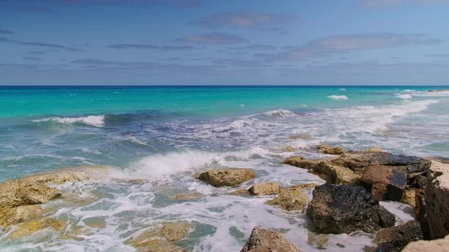 Real-time footage of waves splashing on coastline rocks. Mediterranean sea near El Alamein city, North Coast, Marsa Matrouh governorate, Egypt