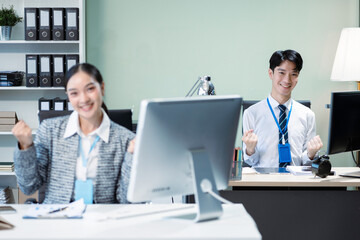 Obraz premium Happy smiling businessman feel happy work complete Teamwork success, success at work in the office concept.