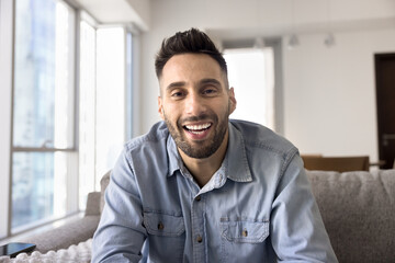 Happy handsome Hispanic man talking on conference chat screen shot, Latin vlogger man looking and...