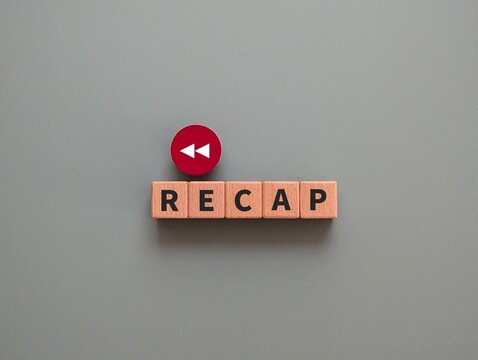 wooden cube with the word Recap and back arrow. flashback concept. business finance