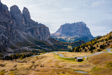 Majestic Dolomites reveal winding roads and tranquil landscapes in early autumn light