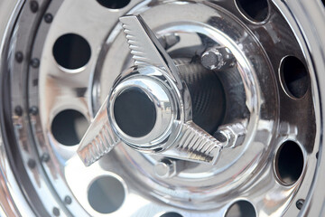 Muscle car detail closeup nickel plated alloy wheel side view.