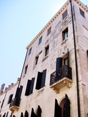 A view from the boat at the ancient Venetian shutters that remain on the windows of houses to this day.