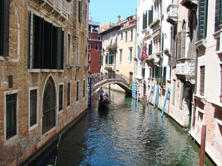 Travel through the narrow waterways of Venice by boat between ancient houses and under the bridges that connect them.