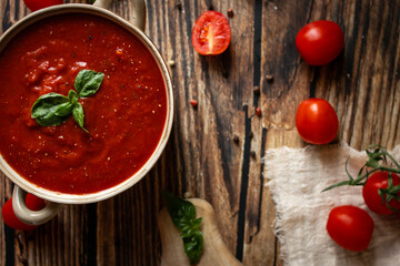 fresh tomato soup in a bowl. on a wooden table. food