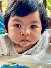 Portrait of a cute little Asian baby girl with looking at camera