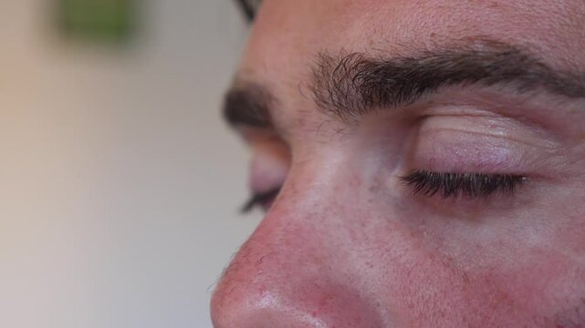 A young man's eyes widen in realization, captured in a side view. This moment of awareness reflects a significant breakthrough in his understanding.