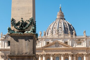 Vatican City and St. Peter's Basilica under blue sky.