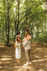 Fototapeta premium Happy family walks in an autumn park