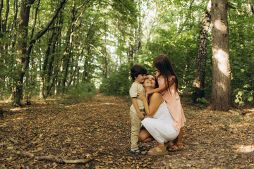 a mother with her son and daughter in the park