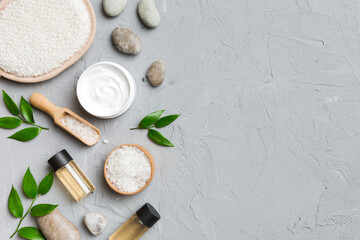 Coconut with jars of coconut oil and cosmetic cream on colored background. Top view. Free space for your text. Natural spa coconut cosmetics and organic treatment concept Coconut Spa composition