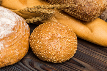 Homemade natural breads. Different kinds of fresh bread as background, perspective view with copy space