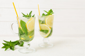 Mojito cocktail. Refreshing mojito cocktail with lime, lemon and mint in a tall glass with a stick