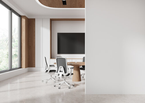 Modern office interior with large windows, blank wall and meeting room setup. 3D Rendering