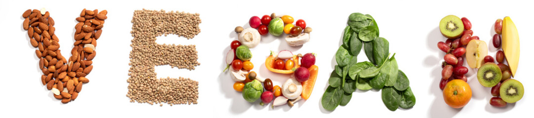 Word Vegan formed by almonds, lentils, mixed vegetables, spinach leaves and fruits on white background