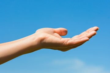 A person holds their hand up in mid-air, open and receptive