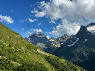 Obraz premium Mount Dombay-Ulgen view from the Dombay village. Sunny summer day. Karachay-Cherkessia, Russia. Caucasus Mountains is a tourist destination.