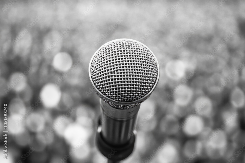 Poster a close-up view of a microphone in monochrome tone