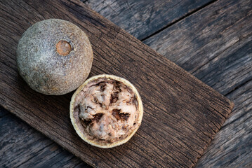 Limonia or Feronia limonia (L.) Swingle fruits on an old wooden  background.top view.