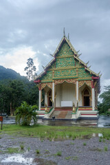 The Wat Tham Panthurat temple in Thailand with rain clouds in the background