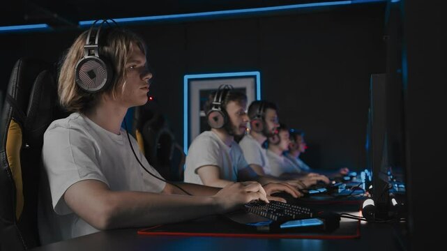 Gamers lose the round map, match defeat in tournament. 5 guys play strategy game in computer club. Multiplayer online battle arena game on desktop computers. Pro cyber team fail at shooter video game