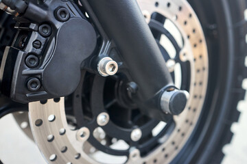 Front disc brakes bike closeup. Front radial mount caliper bike, Motorcycle with Twin Floating Disk Brake and ABS system with copyspace