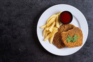 Cachopo, Traditional food in Asturias, Spain. Breaded fillet meat isolated on white background. Top view. Copy space