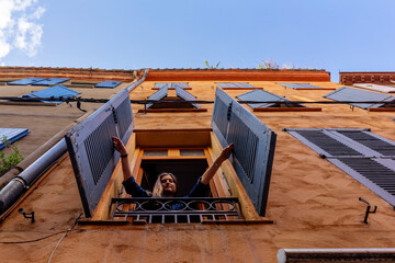 young woman looks out the window