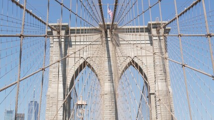 Obraz premium Brooklyn Bridge to Manhattan downtown, cables and blue sky. New York City iconic symbol, USA travel destination. Architecture of United States of America, tourist landmark. Famous cable-stayed bridge.