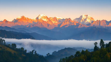 Obraz premium Majestic mountain range at sunrise with wispy clouds and vibrant golden light highlighting the peaks and valleys of the landscape
