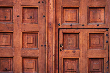 Texture of a vintage wooden gate and a door with a handle. The gates of the Nikolskaya Tower of the Moscow Kremlin. Background.