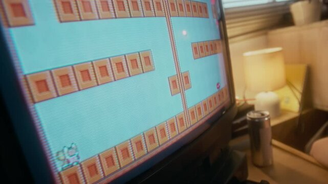 No people closeup shot of pixelated old TV screen with 8 bit arcade console video game, game character reaching end of level, nostalgic 90s