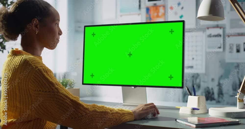 Poster black female engineer engages with desktop computer featuring green chroma key screen. modern office