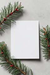 Fototapeta premium Blank white card surrounded by pine branches with red berries
