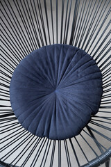 Obraz premium Armchair. Dark metal armchair. Blue cushion on the chair. Minimalistic design. Detail. Interior. Counter. Construction. Concrete background. Concrete walls. Furniture