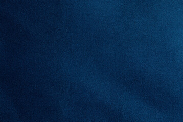Close-up of dark blue fabric texture with a soft, uniform pattern, perfect for backgrounds and design overlays.