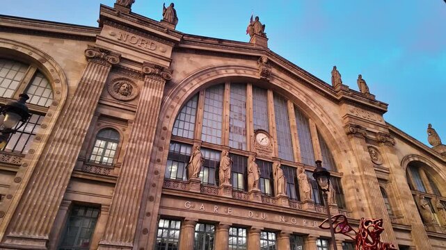 Close-up view about the Gare du Nord mainline railway facade details in sunset, Paris, France.