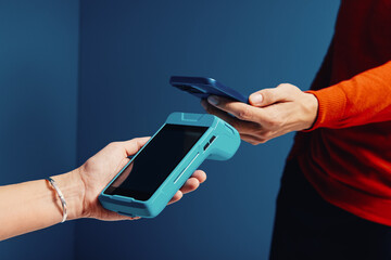 Customer using smartphone for an electronic payment transaction