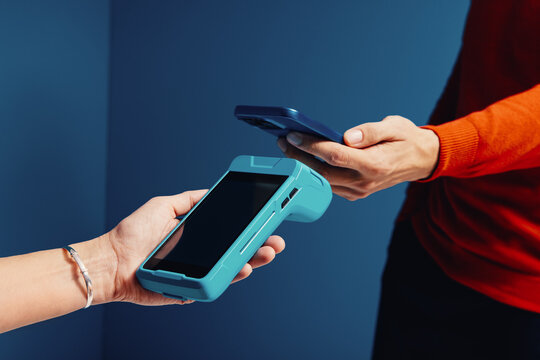 Customer using smartphone for an electronic payment transaction