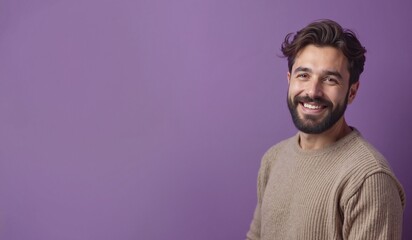 Obraz premium Cheerful man with beard smiling confidently against purple background with copy space