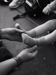 Parent Holding Baby's Feet in Tender Moment