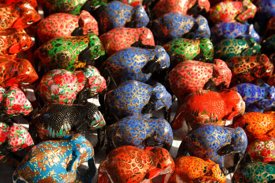 Close-up of assorted colourful elephant ornaments for sale in a local market, New Delhi, India