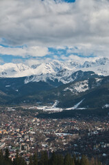 Fototapeta premium Snow-covered mountain peaks in the Tatras above the town of Zakopane in the Polish mountains