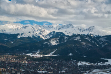 Fototapeta premium Snow-covered mountain peaks in the Tatras above the town of Zakopane in the Polish mountains